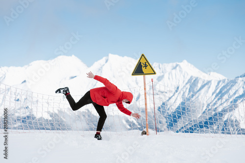 Man showing funny pose from warning sign photo