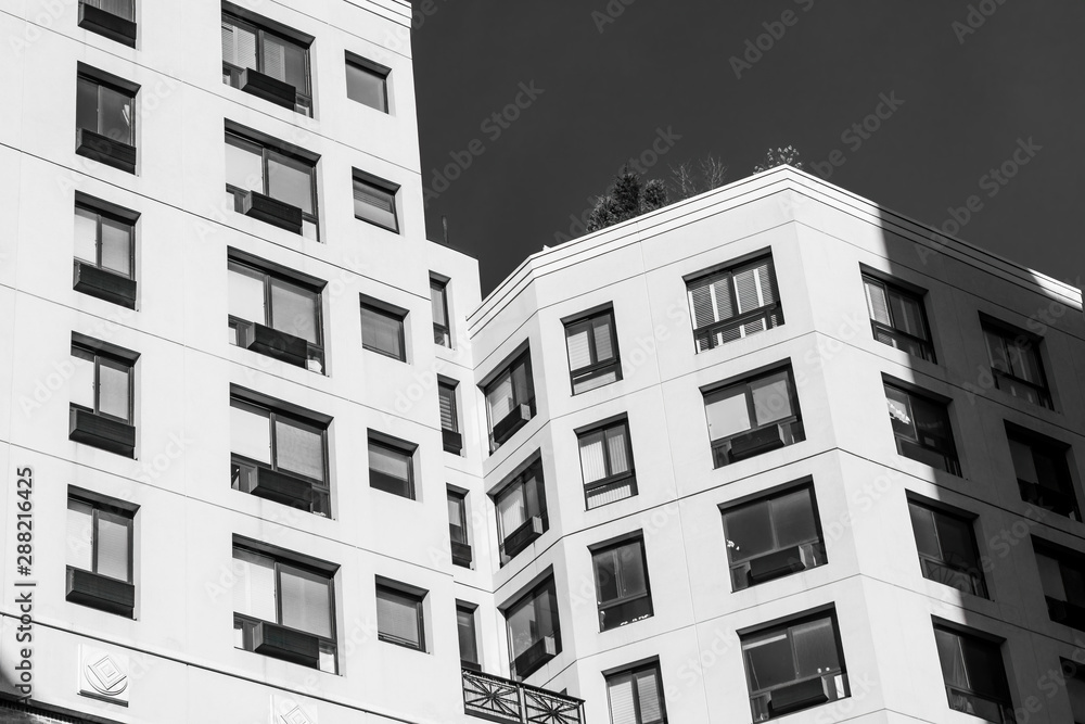 Looking up at the facade of a modern building in Manhattan, New York City, USA, black and white