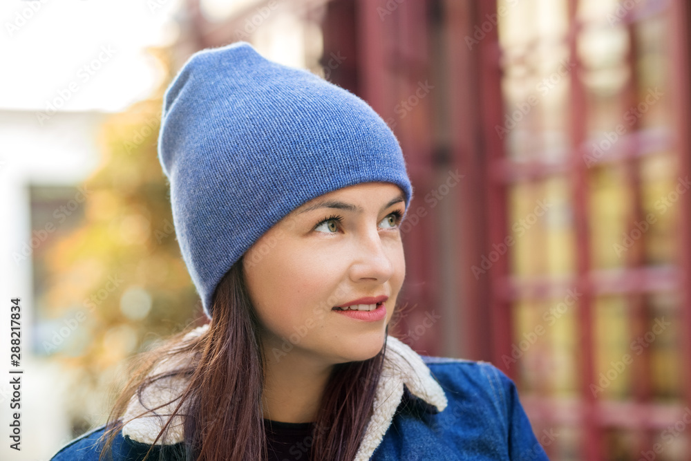 Walk around the city in cold weather. Woman in a blue hat. Concept lifestyle, autumn Walk around the city in cold weather. Woman in a blue hat. Concept lifestyle, autumn