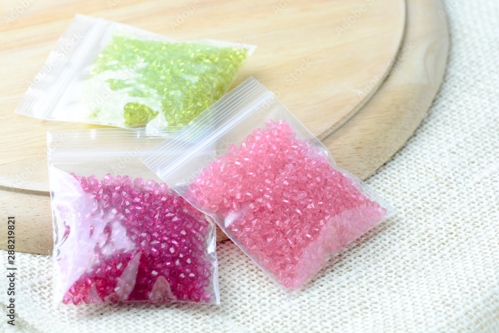 Colorful beads on a wooden surface. Various of shapes and colors to make jewelry Colorful beads on a wooden surface. Various of shapes and colors to make jewelry