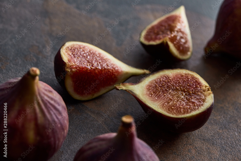 ripe whole and cut delicious figs on stone background ripe whole and cut delicious figs on stone background
