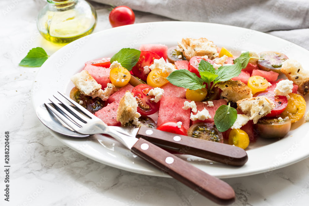 Watermelon salad with feta, tomatoes cherry and mint Watermelon salad with feta, tomatoes cherry and mint