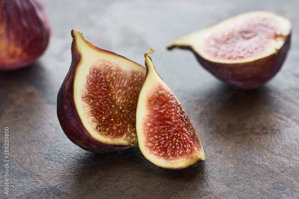 close up view of ripe cut delicious figs on stone background close up view of ripe cut delicious figs on stone background