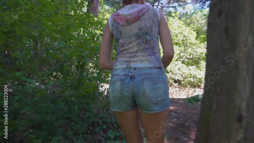Slim Woman in Jeans Shorts and Sandals Walking in Forest Slow Motion
