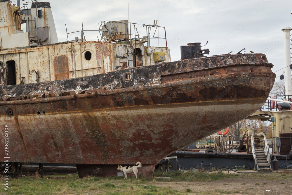 Rusty decommissioned marine ship that was left on the shore. Rusty decommissioned marine ship that was left on the shore.