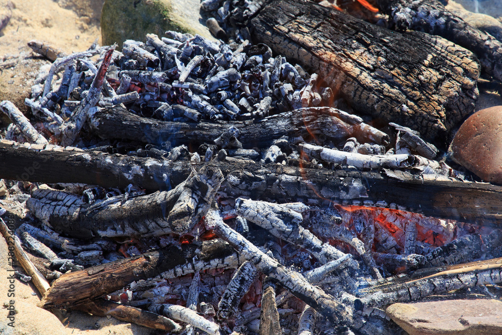 Red-hot smoldering bonfire from wooden branches and twigs. Red-hot smoldering bonfire from wooden branches and twigs.