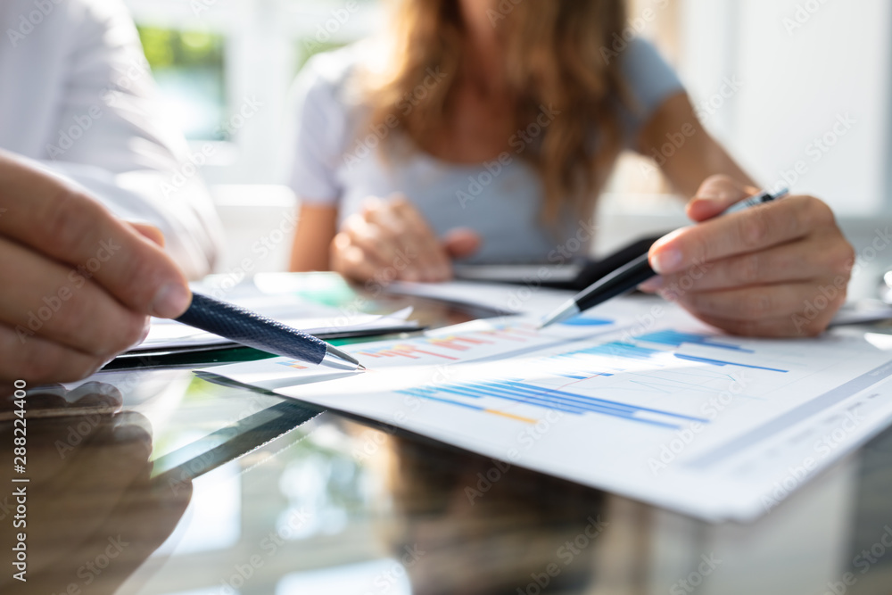 Two Businesspeople Analyzing Graph Two Businesspeople Analyzing Graph