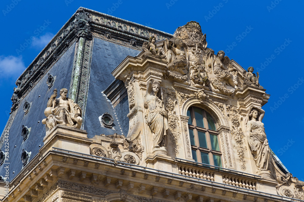 PARIS, FRANCE - JUNE 23, 2017: Gable of the Pavillon Colbert of the Louvre. Is the world largest art museum and is housed in the Louvre Palace, originally built in the late 12th to 13th century.