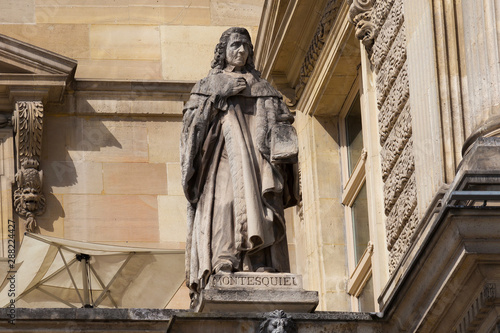 Charles-Louis, Baron de Montesquieu (1689-1755) statue on the Louvre Palace, Paris, France. He was a French judge, man of letters, and political philosopher (famous theory of separation of powers). photo