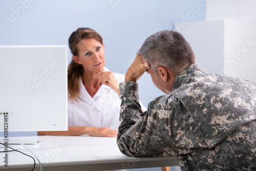 Doctor Counseling Soldier Suffering From Stress