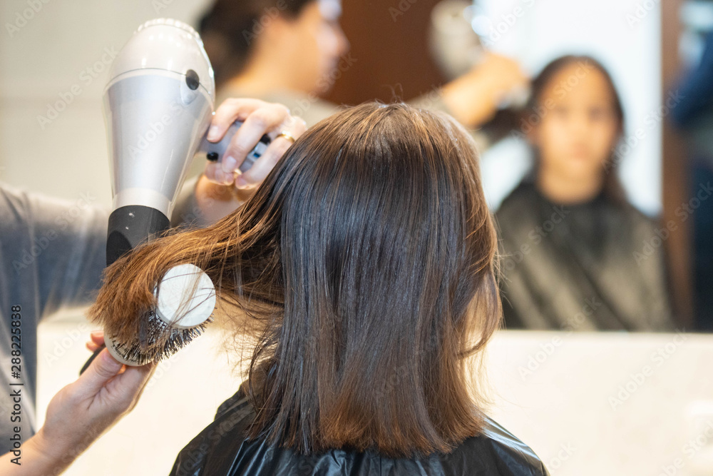 Fototapeta premium Madre cortando el cabello a su hija en casa