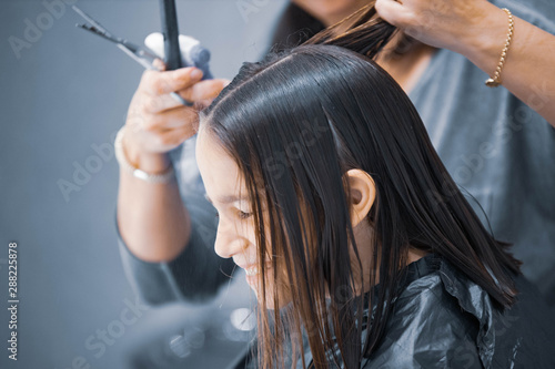 Madre cortando el cabello a su hija en casa