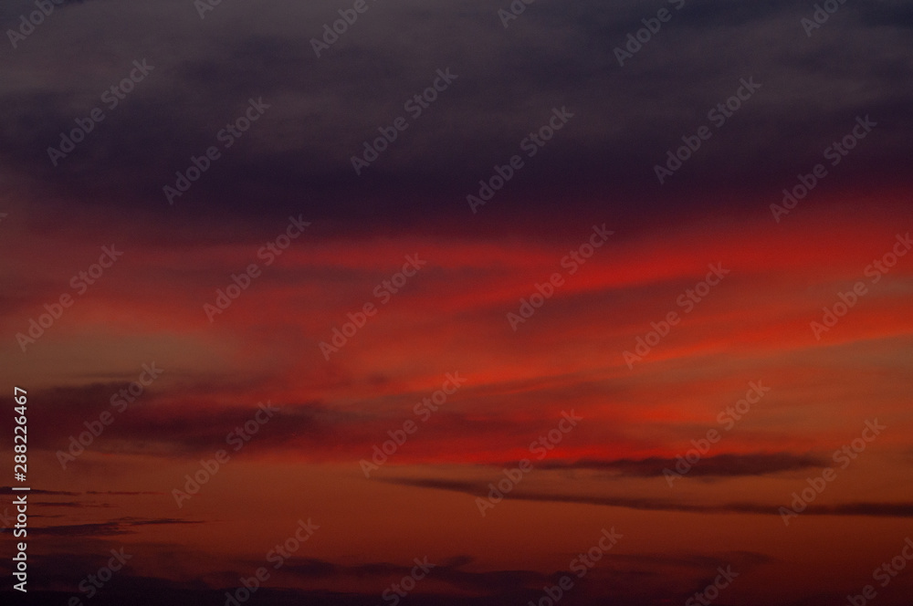 Sunset glow clouds in form of Ukraine map silhouette sky