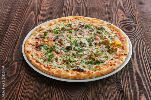Thin crust pizza with ham, pumpkin and oyster mushrooms
