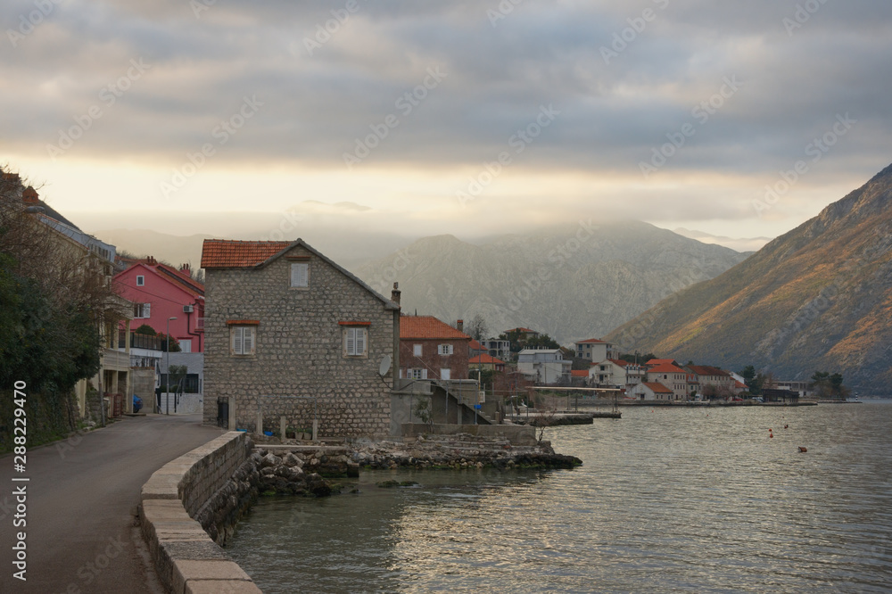 Beautiful evening Mediterranean landscape on winter day. Montenegro, Adriatic Sea. View of Bay of Kotor and Prcanj town