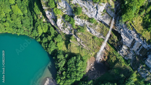 Aerial view of waterfalls in mountains, Klöntalersee lake, Glarus Kanton, Switzerland.