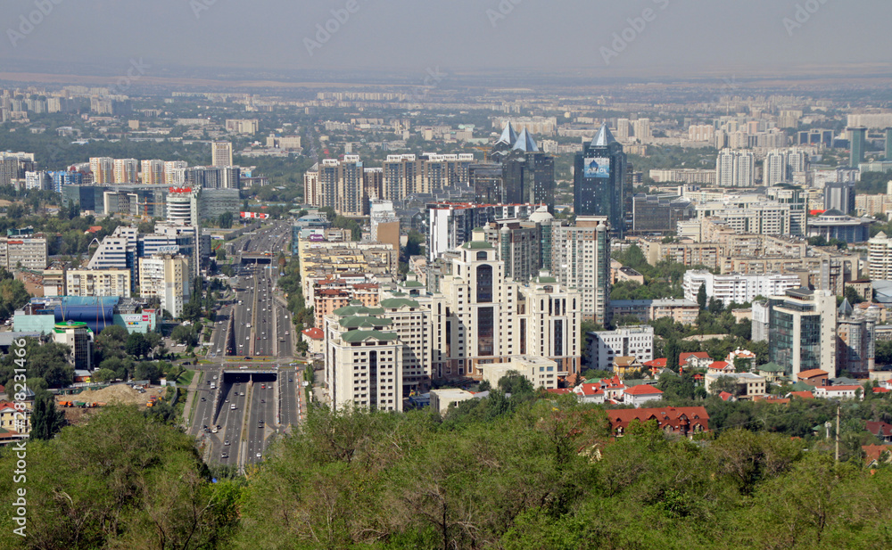 Almaty, Kazakhstan - August 24, 2019: View over the skyline of Almaty with slight smog clouds over the city.