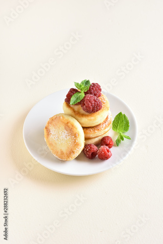 Fototapeta Naklejka Na Ścianę i Meble -  Cottage cheese pancakes with fresh raspberries