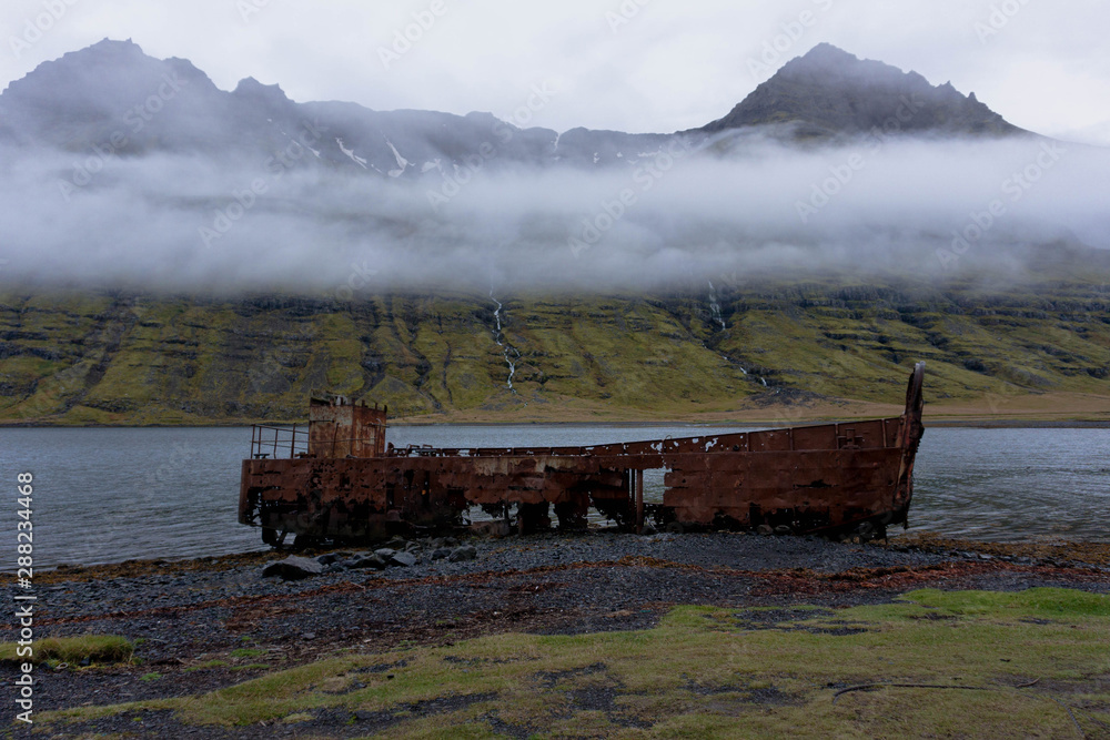 Rusty stranded boat in Mjoifjordur, Iceland