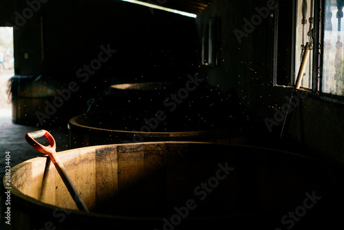 Empty used wooden barrels in old rural warehouse photo