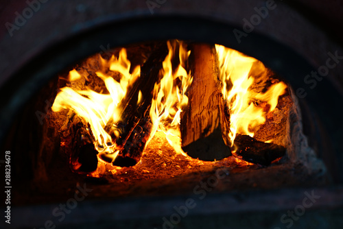 Hot bright burning fire with in oven in darkness