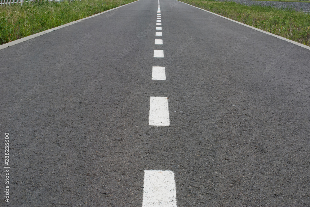 Dark asphalt road with marking lines. Tarmac texture