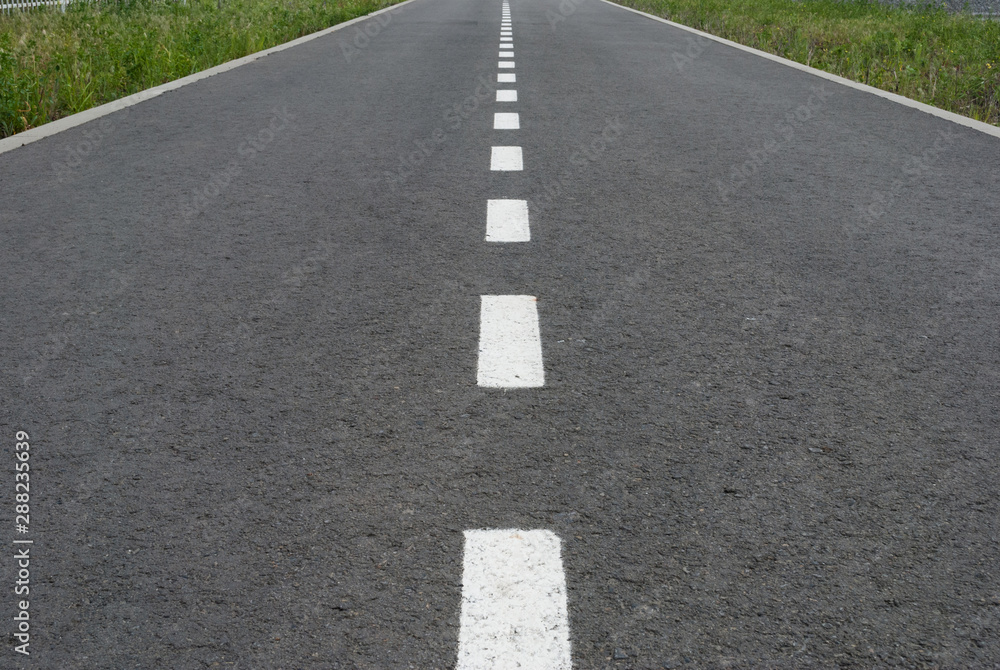 Dark asphalt road with marking lines. Tarmac texture Dark asphalt road with marking lines. Tarmac texture