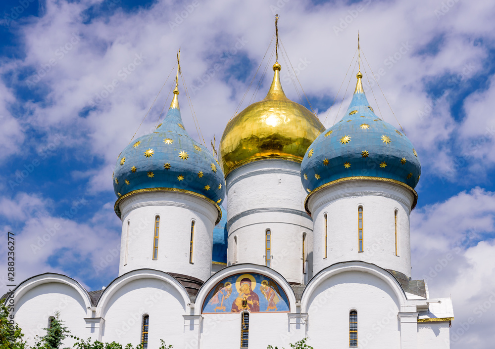 The dome of the Orthodox Cathedral against the blue sky. The Holy Trinity - St. Sergius Lavra in Sergiev Posad near Moscow, Russia, tourist attraction as a part of the Golden Ring of Russia.