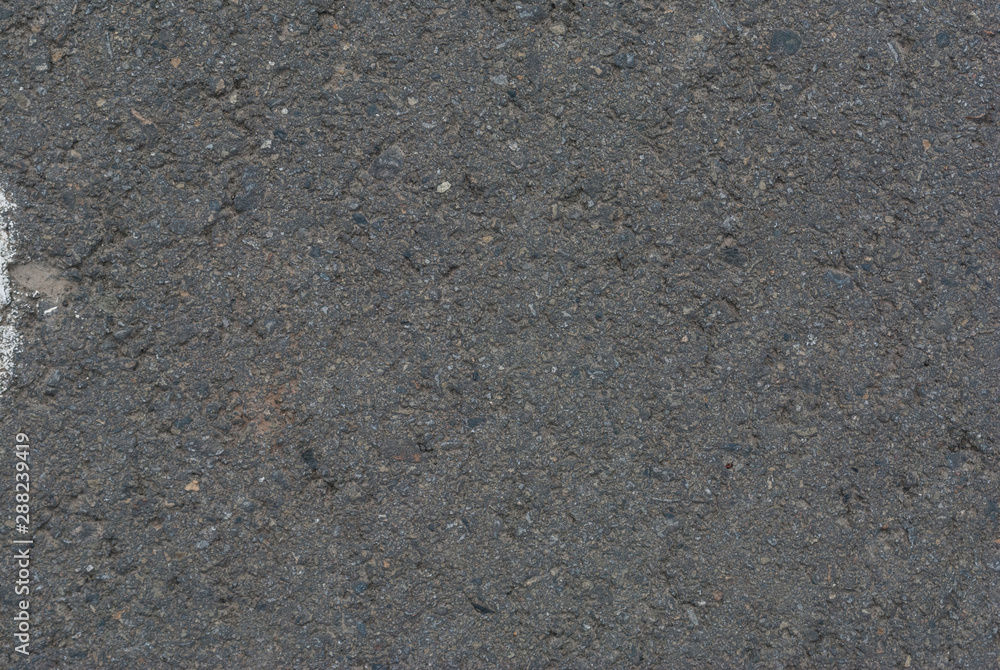 Smooth asphalt road. Tarmac dark grey grainy road background. Top view grunge rough surface Smooth asphalt road. Tarmac dark grey grainy road background. Top view grunge rough surface