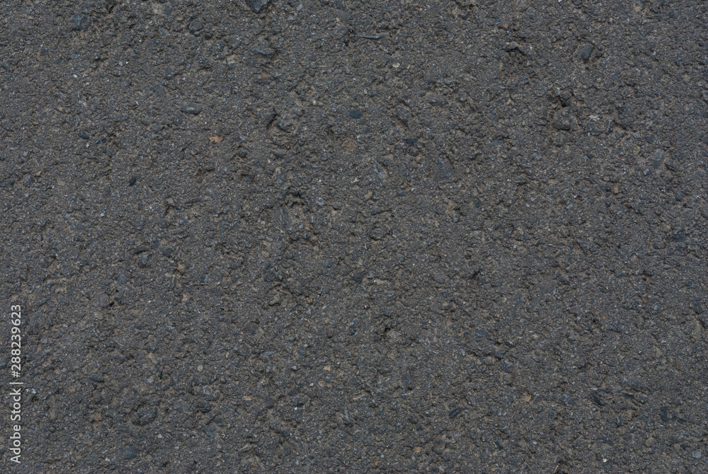 Smooth asphalt road. Tarmac dark grey grainy road background. Top view grunge rough surface Smooth asphalt road. Tarmac dark grey grainy road background. Top view grunge rough surface