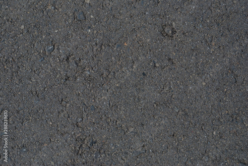 Smooth asphalt road. Tarmac dark grey grainy road background. Top view grunge rough surface photo