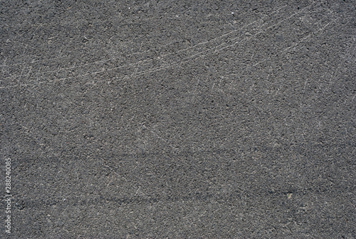 Smooth asphalt road. Tarmac dark grey grainy road background. Top view grunge rough surface photo