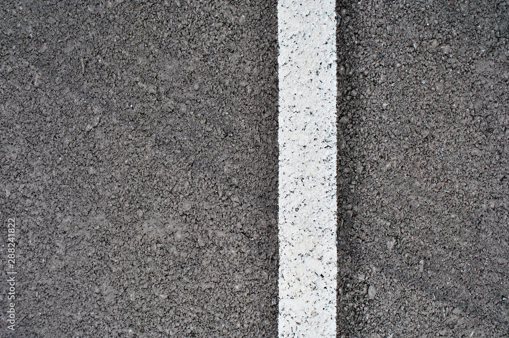 Fototapeta premium Asphalt texture with white line and tire marks . Top view
