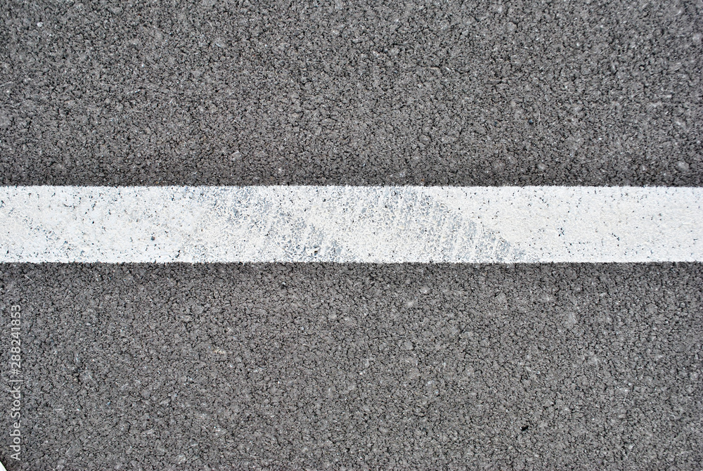 Fototapeta premium Asphalt texture with white line and tire marks . Top view