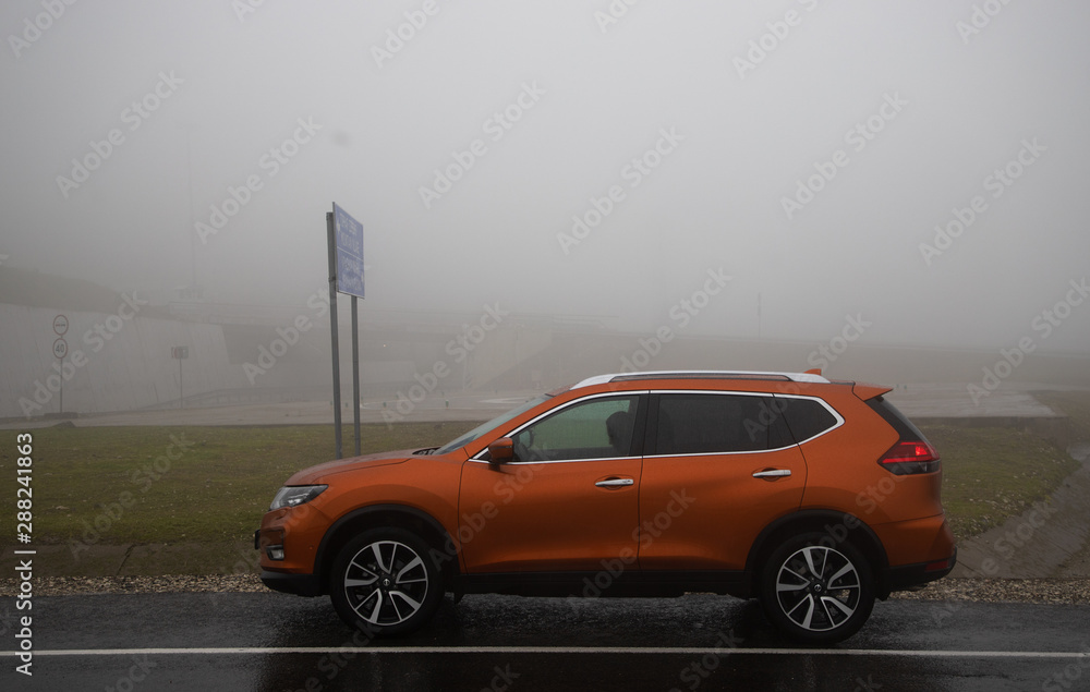 orange car on the road in mountains