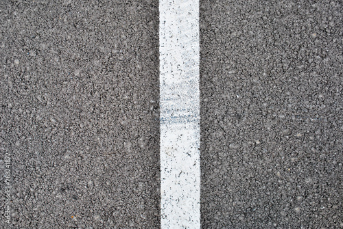 Asphalt texture with white line and tire marks . Top view