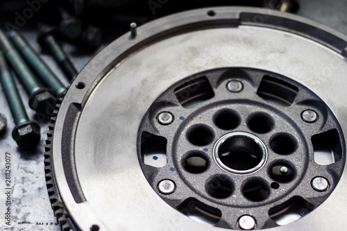 dual-mass flywheel with fastener parts in the background photo