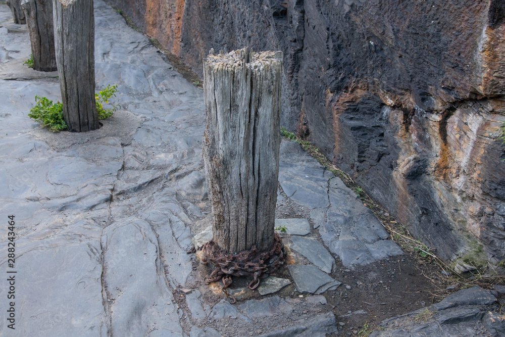 Weathered wooden mooring post with chain rusted to it, Boscastle, Cornwall Weathered wooden mooring post with chain rusted to it, Boscastle, Cornwall
