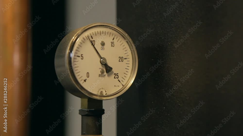Circular industrial pressure gauges on a coffee bean roasting machine