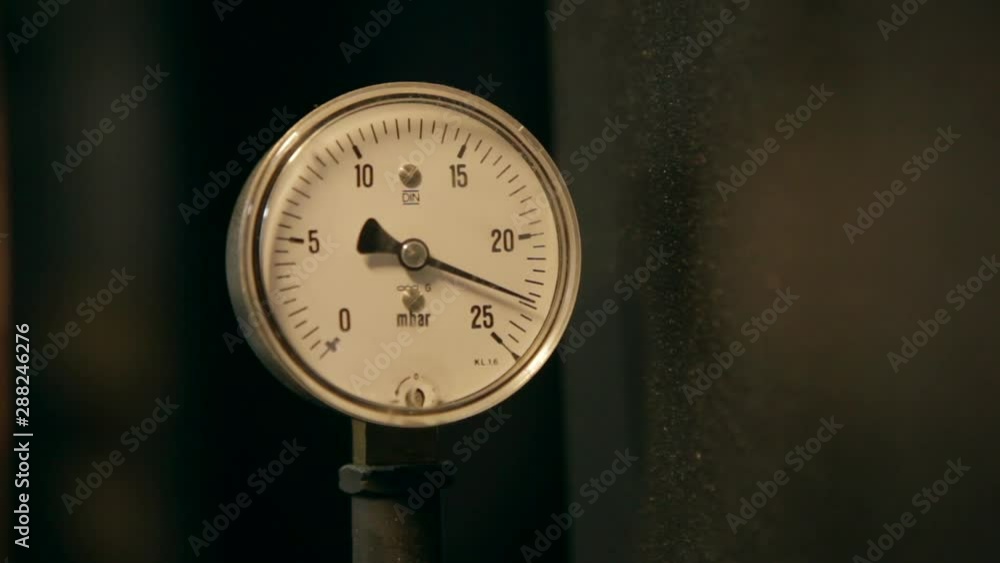 Circular industrial pressure gauges on a coffee bean roasting machine