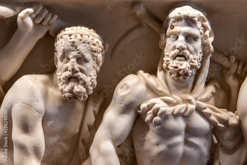 Detail of old marble sculptures showing primitive men