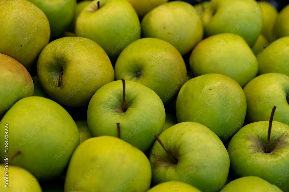 .Green apples on a storefront for sale .Green apples on a storefront for sale