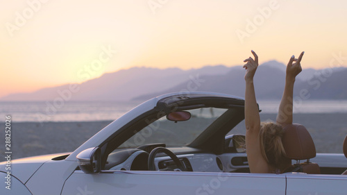 Young Woman in Cabriolet at Sunset © drdonut