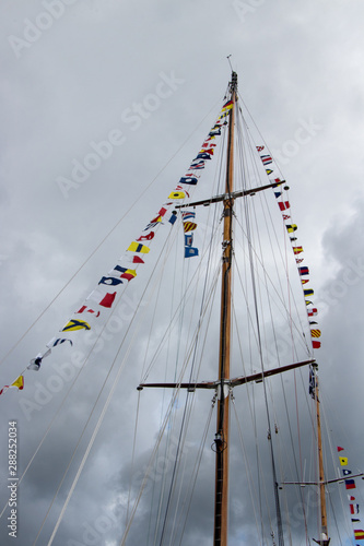 signal flags blowing in the wind on the mast of a tall ship