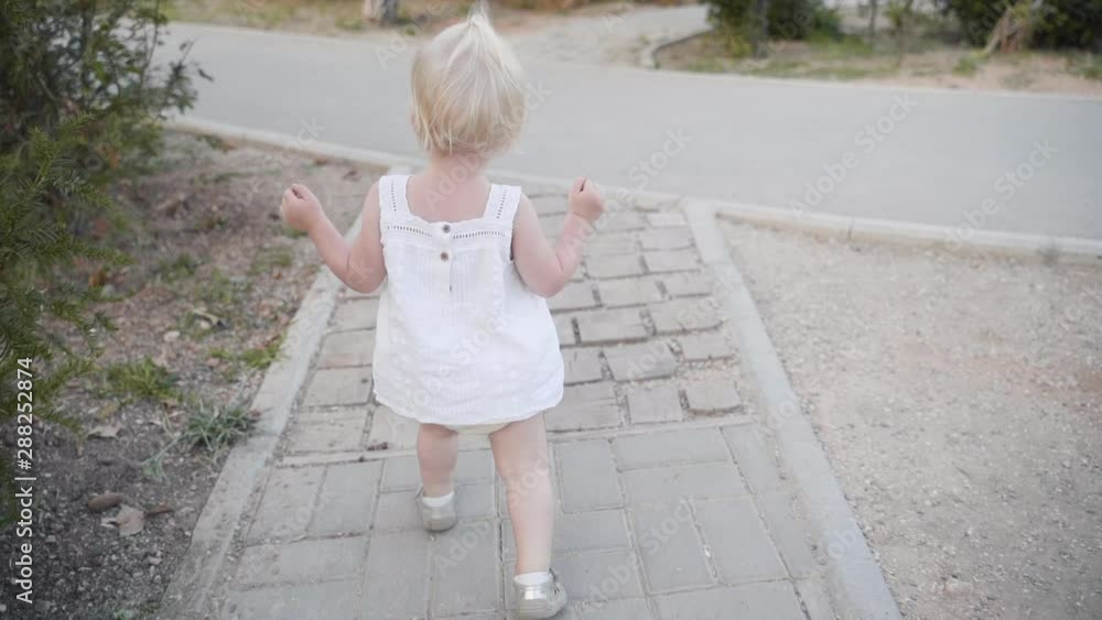 Little baby girl walking outdoor at summer Little baby girl walking outdoor at summer
