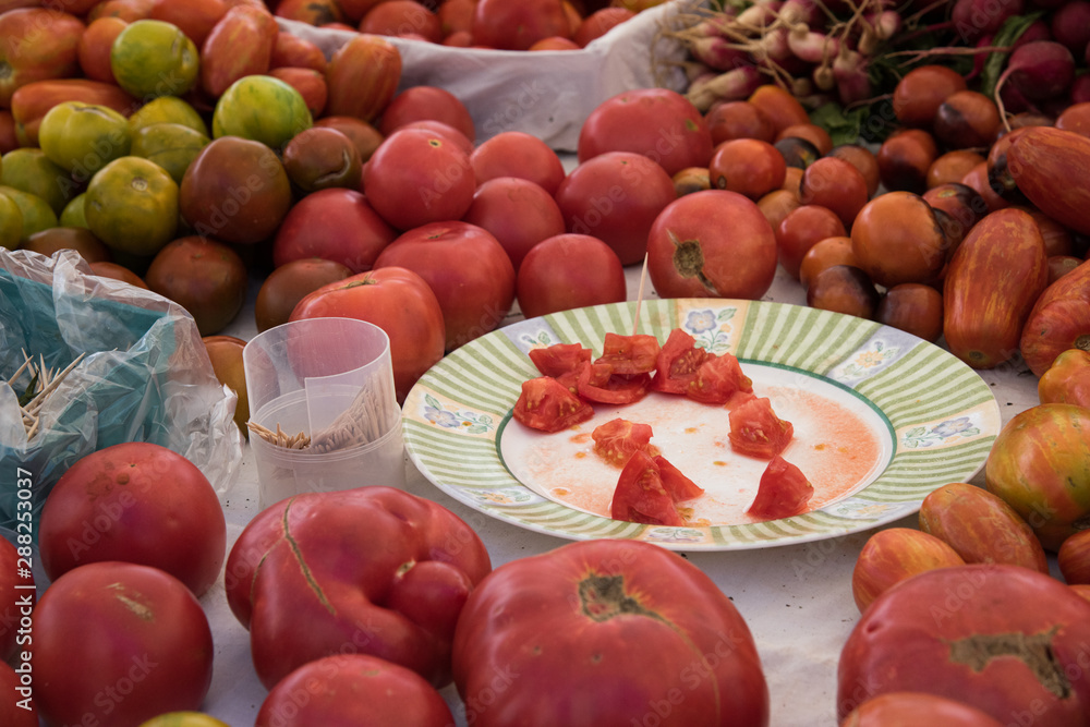 Pieces of tomatoes cut for samples at the market Pieces of tomatoes cut for samples at the market
