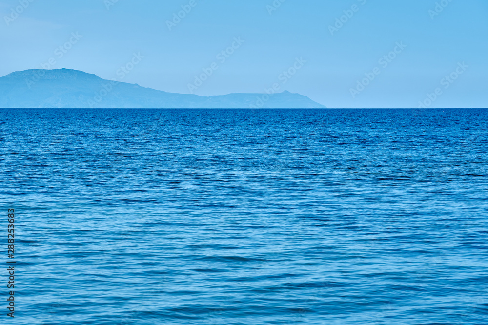                                Blue sea water texture with foggy sea coast on a horizon. Copy space.