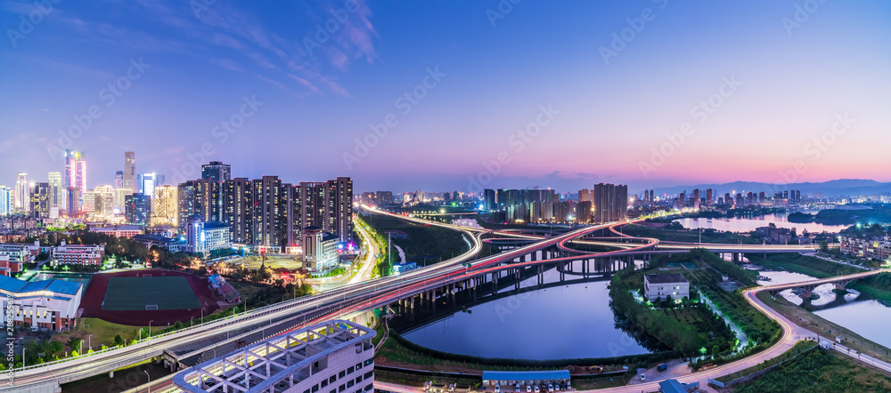 Fototapeta premium Freeway in night with cars light in modern city. 