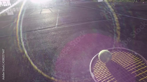 beginner tennis player plays and hits the ball. first-person view