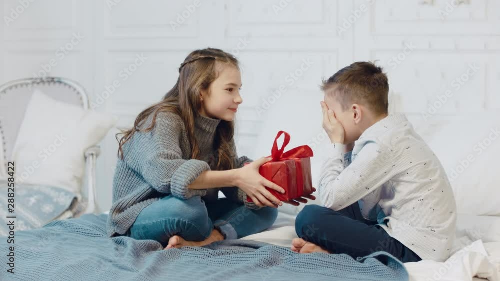 Surprised boy getting present box in new year apartment. Surprised boy getting present box in new year apartment.